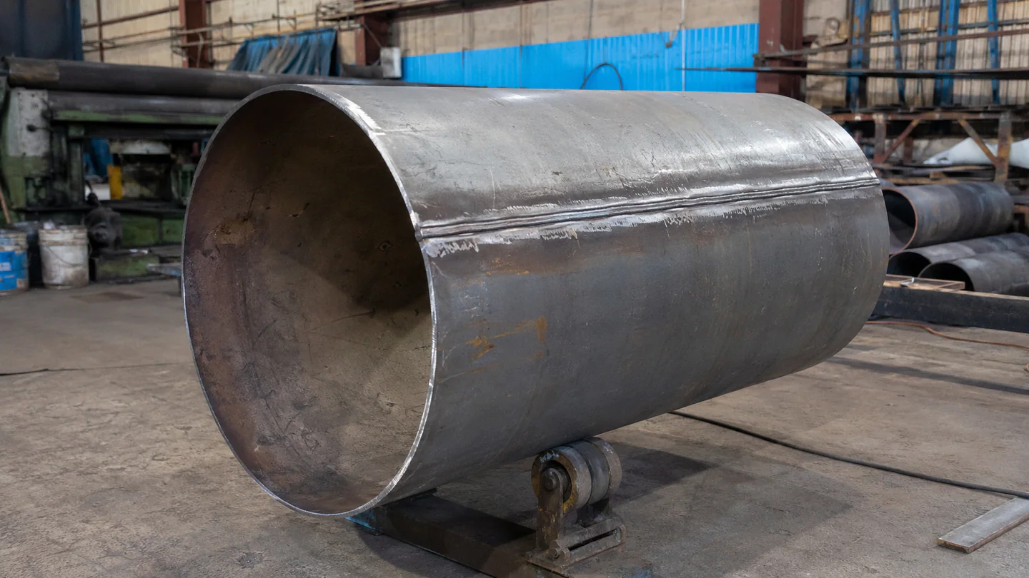 Large conveyor pulley shell being fabricated in a workshop