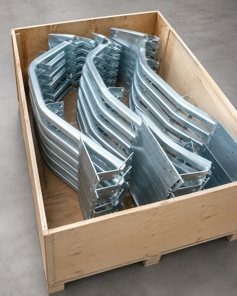 Galvanized conveyor brackets and small structural supports packed in a crate