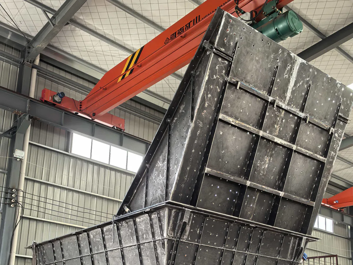 Fabricated mining feed hopper showing internal and external wear-zone interfaces