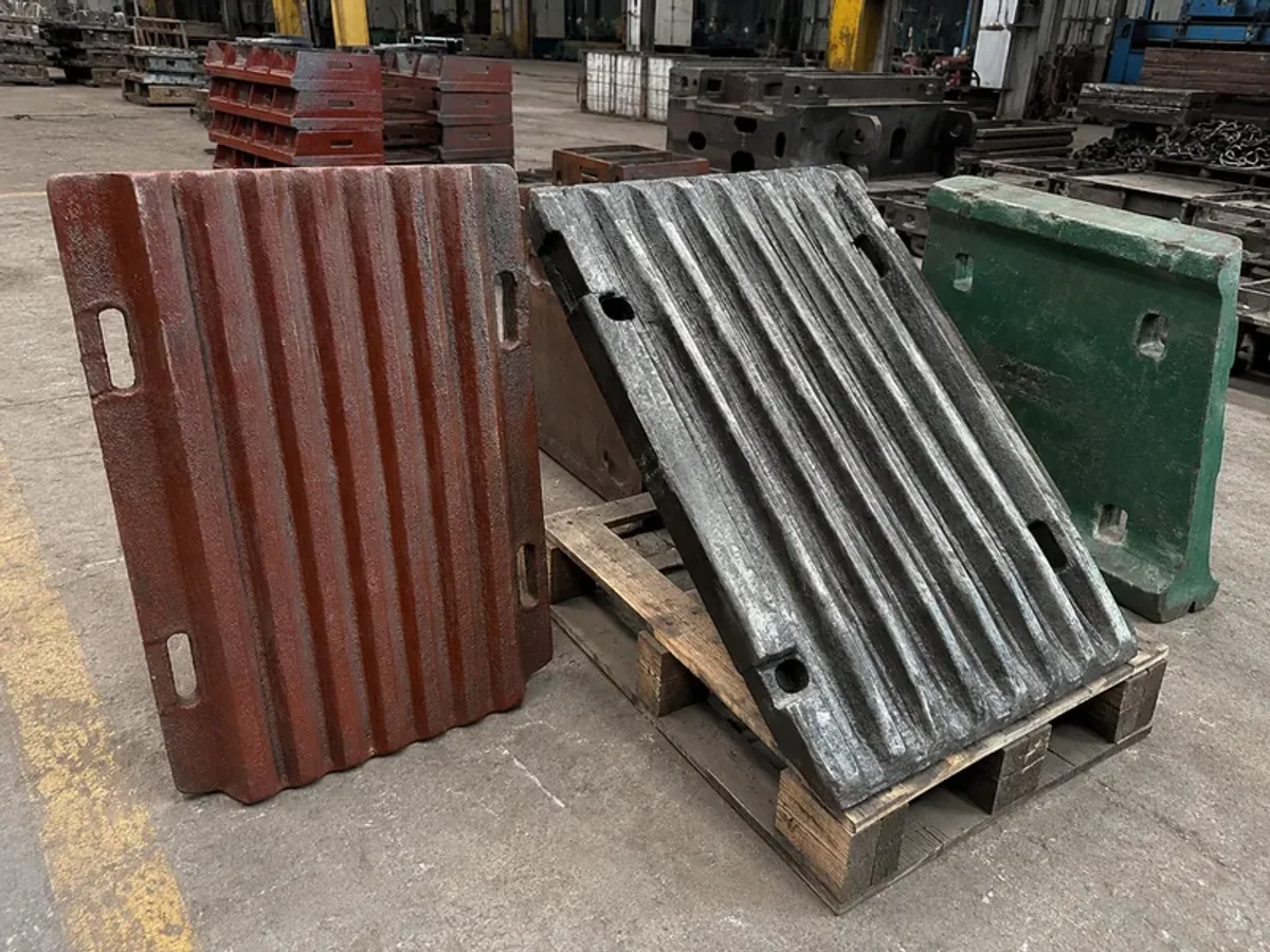 Jaw plates showing different wear-face conditions in a workshop