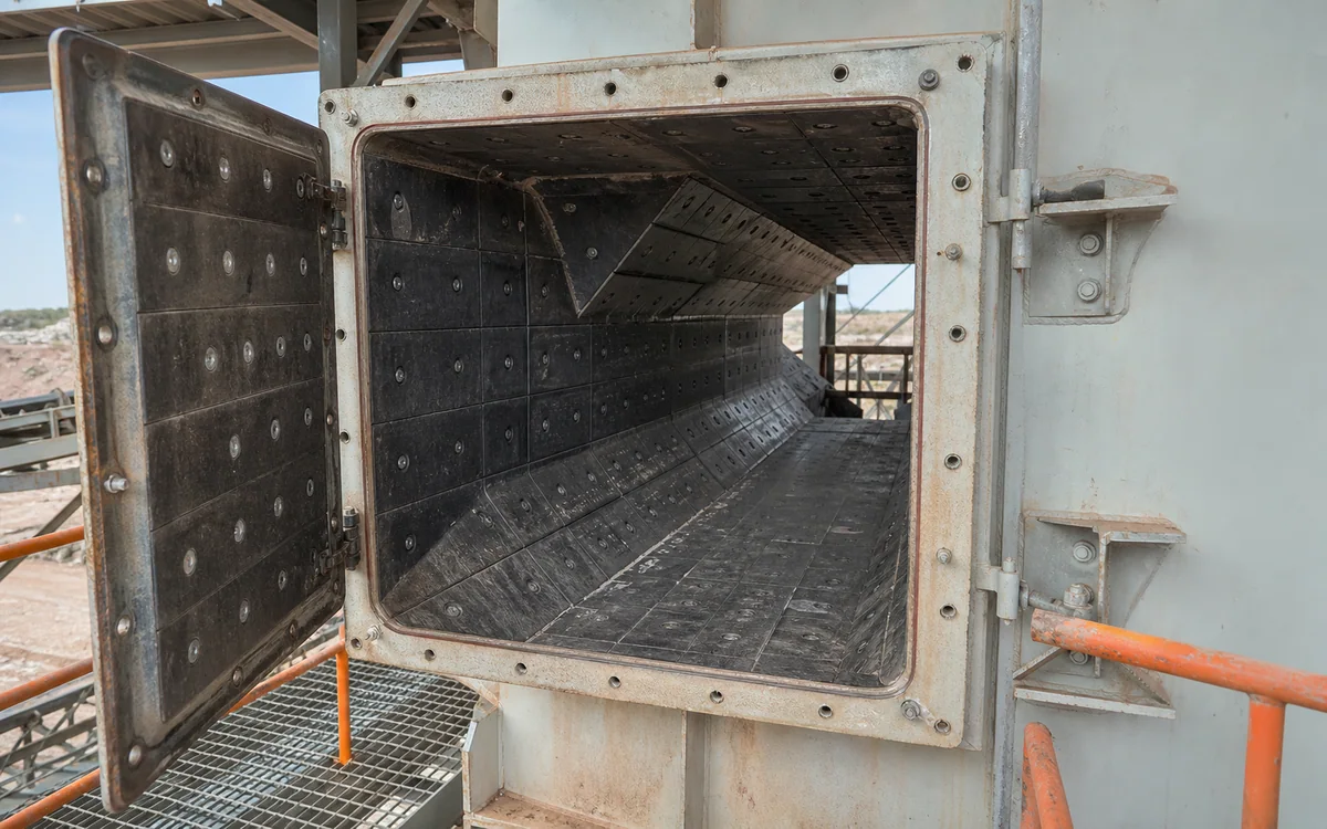 Segmented wear liner panels installed inside a transfer chute