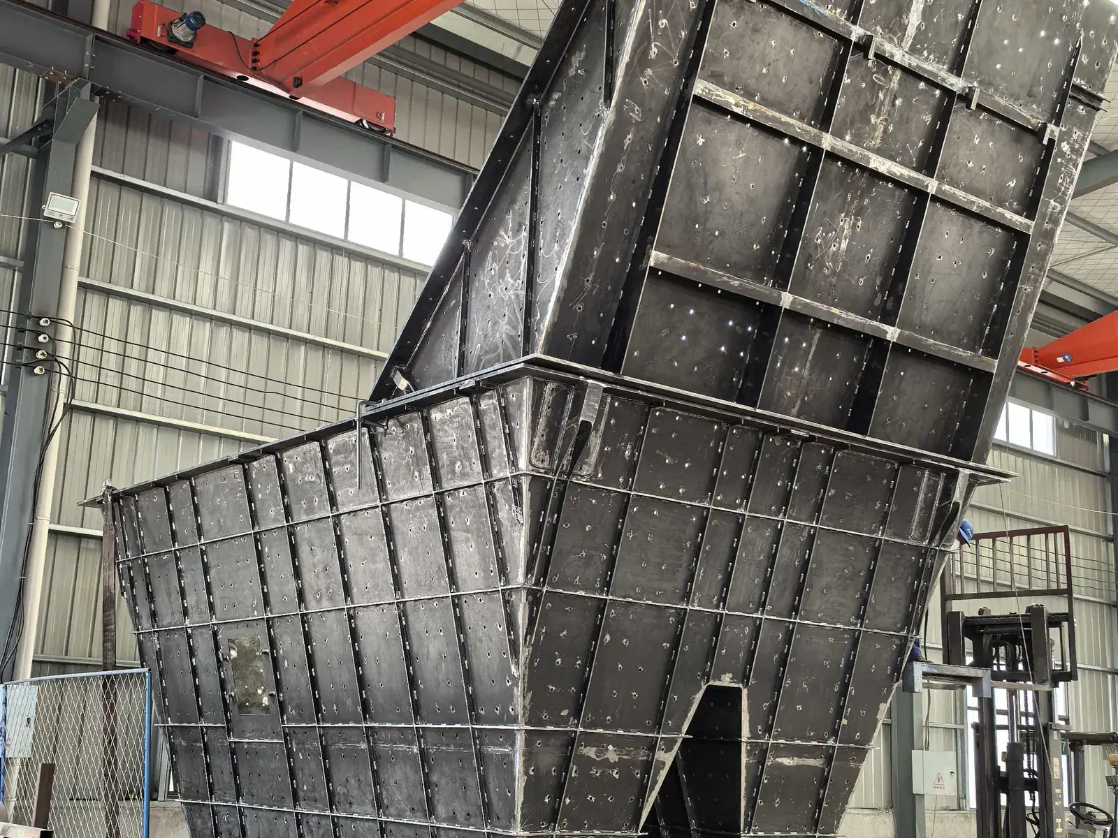 Fabricated feed hopper for a drawing-defined material handling interface