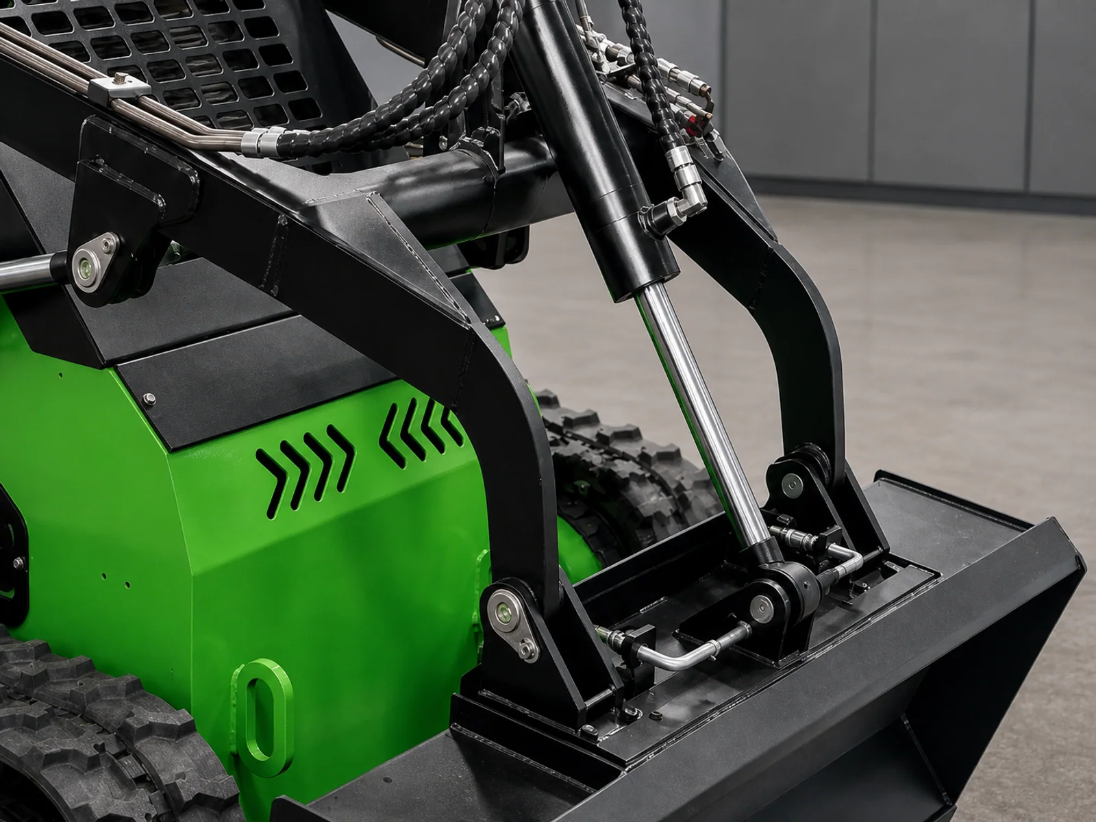 Close view of a compact tracked loader front attachment and hydraulic interface