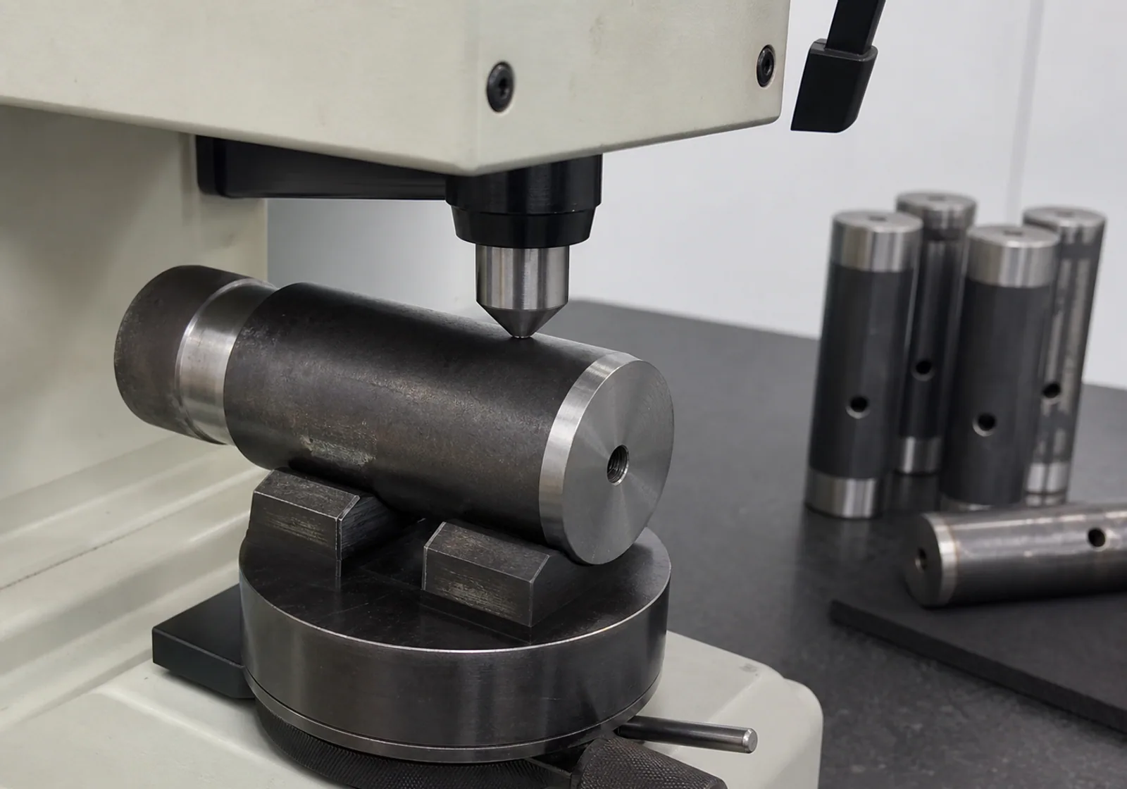 Hardness test being performed on a machined steel pin